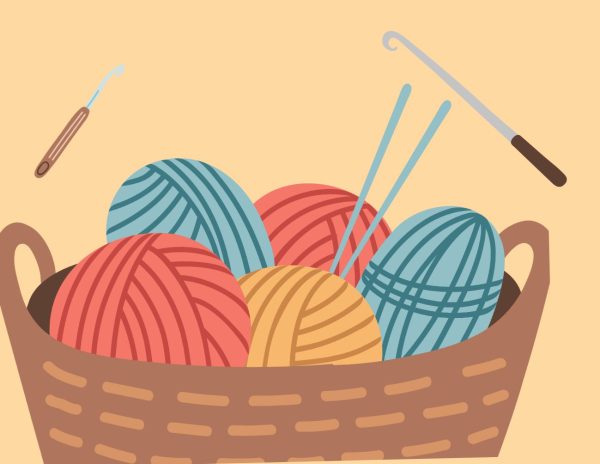 Basket of yarn with knitting needles and crochet hooks