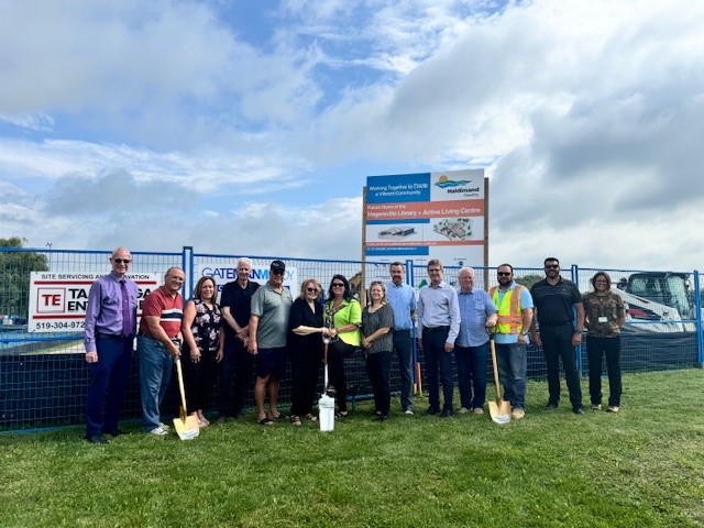 County staff, council and contractors hold shovels in front of the Hagersville Library and Active Living Centre construction site.